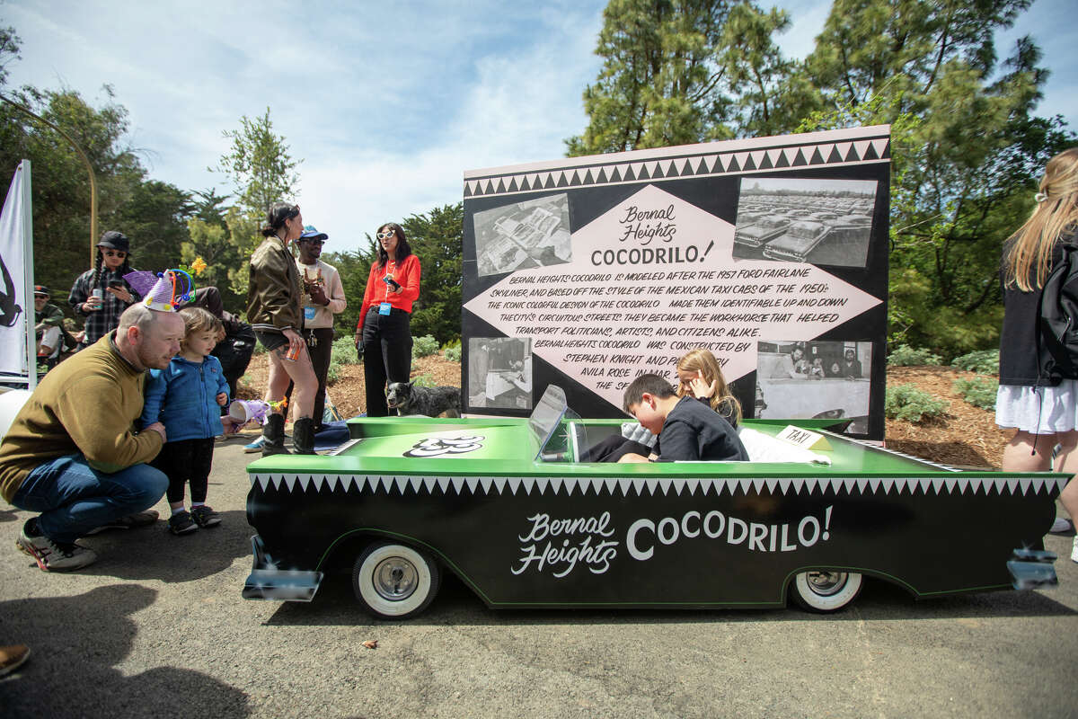 Los espectadores disfrutan y ven a un corredor de caja de jabón en el foso de la carrera durante el SFMOMA Soapbox Derby en McLaren Park en San Francisco, California, el 10 de abril de 2022.