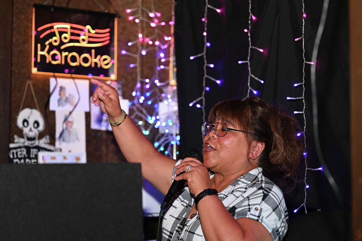 El organizador del karaoke canta una canción en Mel-O-Dee's Cocktails en El Cerrito, California, el jueves 11 de febrero de 2023.