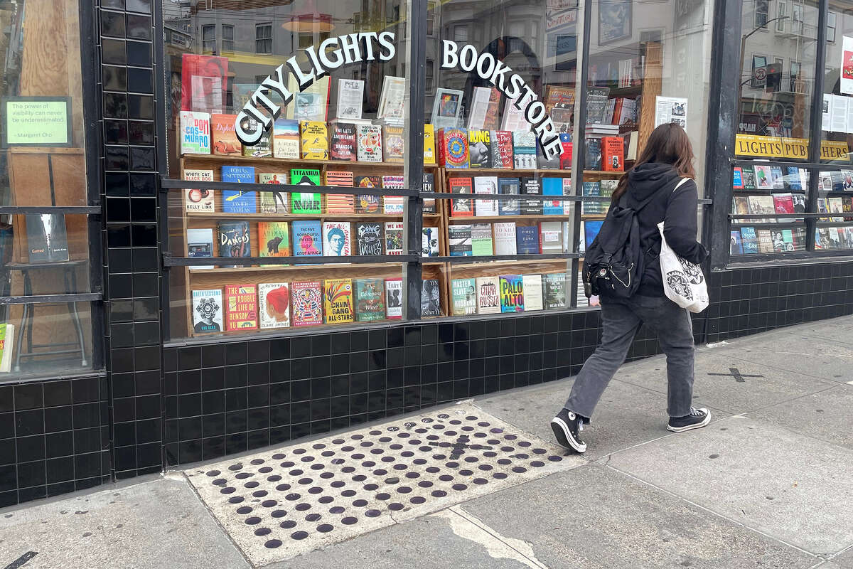 Un peatón pasa frente al conjunto de luces de la bóveda frente a City Lights Booksellers & Publishers en San Francisco el jueves 25 de mayo de 2023. 